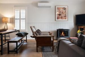 a living room with a couch and a fireplace at Greenlands in Hepburn Springs