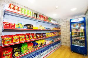 a store aisle with shelves of food and drinks at Star Romantic in Batu Pahat