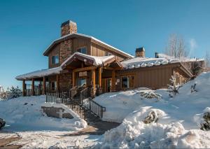 a house in the snow with snow around it at BH5555 Slalom Lodge in Park City