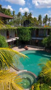 a large swimming pool in front of a building at Mangroove Bay Boutique Hostel in Banyuwedang