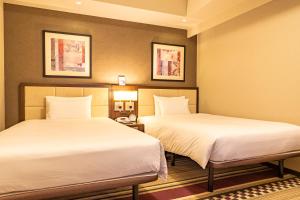Postel nebo postele na pokoji v ubytování Hotel Sunroute Plaza Shinjuku