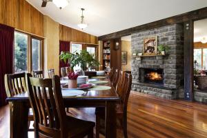 a dining room with a table and a fireplace at Gumtree Spring in Daylesford