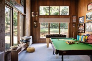 a billiard room with a pool table and windows at Gumtree Spring in Daylesford