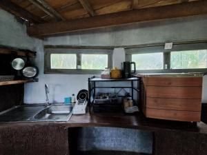 a kitchen with a sink and a counter top at Big Hug Home in Ko Yao Noi
