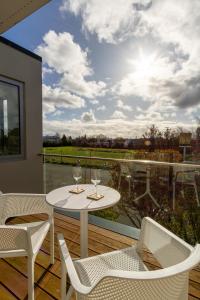 a white table and chairs on a balcony with a view at The Cozy Cocoon 1 Bed 1 Bath Apartment in Christchurch