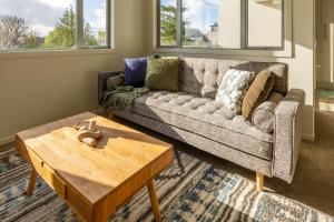 a living room with a couch and a coffee table at The Cozy Cocoon 1 Bed 1 Bath Apartment in Christchurch