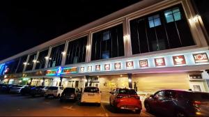 a building with cars parked in a parking lot at Star Romantic in Batu Pahat