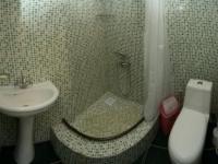 a bathroom with a toilet and a sink at Guest House Fairy Tale in Kaji-Say