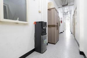 a hallway with a refrigerator in a building at RedDoorz @ Tanjung Sari Surabaya in Tandjung-lor