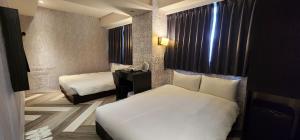 Letto o letti in una camera di 慶爾喜旅館西門捷運館Gugis Inn