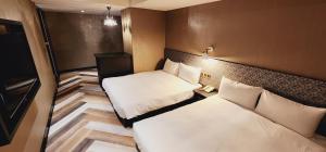 Letto o letti in una camera di 慶爾喜旅館西門捷運館Gugis Inn