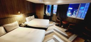 Letto o letti in una camera di 慶爾喜旅館西門捷運館Gugis Inn