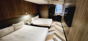 Letto o letti in una camera di 慶爾喜旅館西門捷運館Gugis Inn