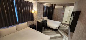 Letto o letti in una camera di 慶爾喜旅館西門捷運館Gugis Inn