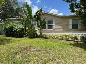 a house with a palm tree in the yard at Pink Flamingo House in Cocoa