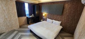 Letto o letti in una camera di 慶爾喜旅館西門捷運館Gugis Inn