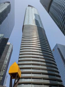 a tall building with a yellow object in front of it at ICE Condominiums in Toronto