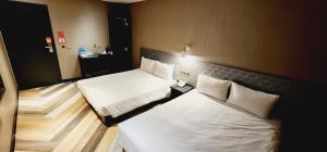 Letto o letti in una camera di 慶爾喜旅館西門捷運館Gugis Inn