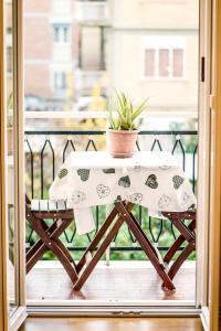 a table on a balcony with a plant on it at Lovely apartment in Rome - Casetta Mattei in Rome