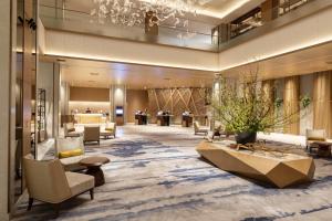 a lobby of a hotel with chairs and tables at The Westin Miyako Kyoto in Kyoto