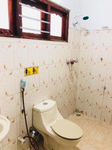 a bathroom with a toilet and a sink at Kandyan Holiday Center in Kandy