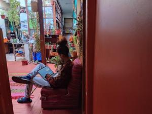 a person sitting on a couch with a laptop at Casa de Sila in Cusco