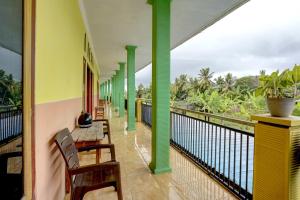 a balcony with benches and a view of the ocean at SPOT ON 92827 Anisah Adil Homestay Syariah in Banyuwangi