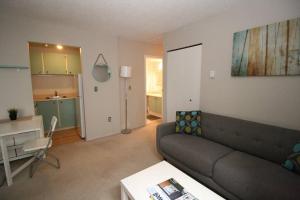a living room with a couch and a table at Kitsilano Beach Executive Condo in Vancouver