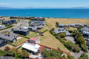 an aerial view of a village with houses and the ocean at Lakeside Haven - Taupo Holiday Home in Taupo