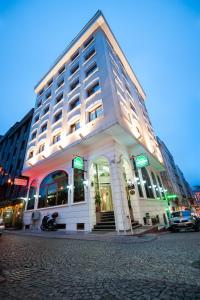 a large white building on a city street at Hotel Centrum Istanbul in Istanbul