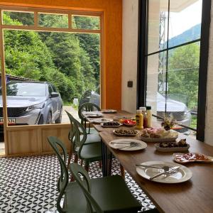 a dining room with a table and a view of a car at Nanus Ayder Apart and Restoran in Rize