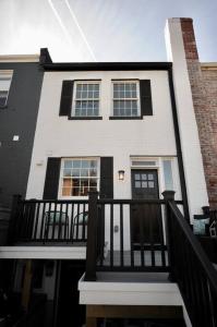 a white and black house with a black fence at Cherry Blossom Townhouse, Easy DC Access in Washington