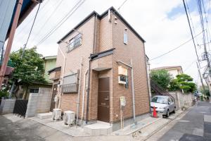 a brick building with a car parked in front of it at Ferio101 in Tokyo