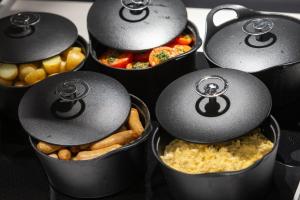 a group of pots filled with different types of food at Crowne Plaza - Marseille Le Dôme in Marseille