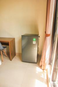 Olivia SOHO Guest House في ليغِيان: ثلاجة صغيرة في زاوية الغرفة