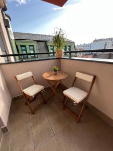 einen kleinen Tisch und zwei Stühle auf dem Balkon in der Unterkunft Plava Zvezda Centar Free Garage in Novi Sad