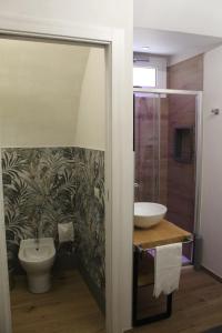 a bathroom with a sink and a toilet at Terrazza Campailla in Modica
