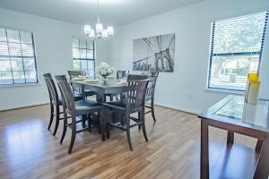 a dining room with a table and chairs at 5 Bd Villa Home Theater Private Pool Game Room in Davenport