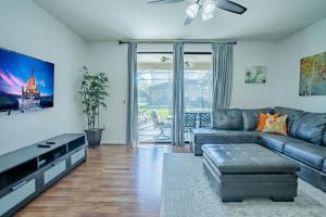 a living room with a couch and a tv at 5 Bd Villa Home Theater Private Pool Game Room in Davenport