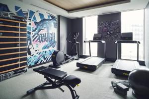 a gym with two treadmills and two exercise bikes at Hotel Indigo Tokyo Shibuya in Tokyo