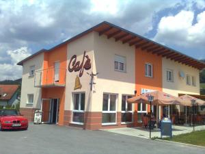 a coca cola building with a car parked in front at Die Glocke in Anger