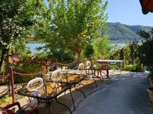 a group of tables and chairs with a view of a lake at Bungalow- casute in Orşova