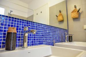 a bathroom with a sink and a mirror at Daphne's place in Vívlos