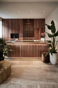 a lobby with a reception desk and a potted plant at Hotel Jarolim in Bressanone