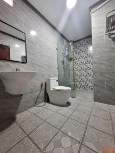 a bathroom with a sink and a toilet and a shower at Le KhounSok Boutique Hotel in Luang Prabang