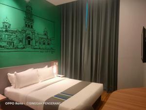 Postel nebo postele na pokoji v ubytování Singgah Pengerang Hotel