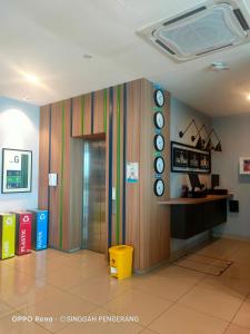 an office lobby with a colorful wall with a window at Singgah Pengerang Hotel in Pengerang