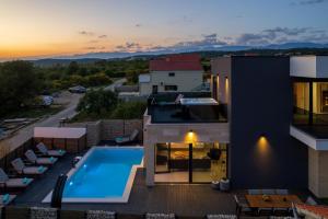 an aerial view of a house with a swimming pool at Kala in Ražanac