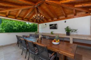 a dining room with a large wooden table and chairs at Vesna Branka in Pićan