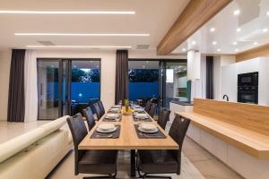 a dining room with a long wooden table and chairs at Stromboli in Sveti Petar